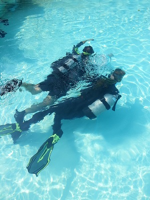 Mark and Emmy Scuba Diving under water simulating a blind diver